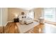 Cozy bedroom with hardwood floors, neutral colors, and a comfortable seating area at 2300 Richardson Dr, Charlotte, NC 28211
