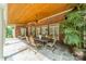 Charming covered patio with brick and wood accents, outdoor seating, and a ceiling fan at 2300 Richardson Dr, Charlotte, NC 28211