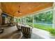 Inviting covered patio with stone flooring, ceiling fans, and view of the backyard and basketball court at 2300 Richardson Dr, Charlotte, NC 28211