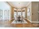 Cozy dining area with modern chandelier, hardwood floors, and large windows offering lots of natural light at 2300 Richardson Dr, Charlotte, NC 28211