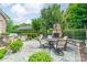 Outdoor patio with built in BBQ, stone fireplace, table and chairs perfect for entertaining at 2300 Richardson Dr, Charlotte, NC 28211