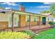 Exterior shot of the home and back porch showing brick facade and yard at 2326 Horseshoe Bend Ne Rd, Hickory, NC 28601