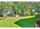 Grassy backyard with a swingset and storage shed surrounded by mature trees at 2326 Horseshoe Bend Ne Rd, Hickory, NC 28601