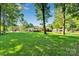 View of the home from the spacious backyard showing lush lawn and mature trees at 2326 Horseshoe Bend Ne Rd, Hickory, NC 28601