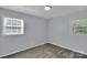 View of a carpeted bedroom with two windows and light blue painted walls at 2326 Horseshoe Bend Ne Rd, Hickory, NC 28601