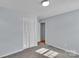Cozy carpeted bedroom featuring a closet, light blue walls, and two windows at 2326 Horseshoe Bend Ne Rd, Hickory, NC 28601