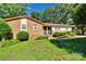 Attractive brick home featuring a meticulously landscaped front yard with lush greenery at 2326 Horseshoe Bend Ne Rd, Hickory, NC 28601
