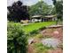 Quaint single-story home with a carport, complemented by mature trees and well-manicured landscaping at 2326 Horseshoe Bend Ne Rd, Hickory, NC 28601