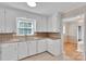 This kitchen has white cabinets, tile flooring, double sinks, and granite countertops at 2326 Horseshoe Bend Ne Rd, Hickory, NC 28601
