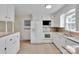 View of the kitchen with white cabinets, a refrigerator, microwave and tile backsplash at 2326 Horseshoe Bend Ne Rd, Hickory, NC 28601