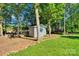 Shot of the storage shed on a lush lot with mature trees at 2326 Horseshoe Bend Ne Rd, Hickory, NC 28601