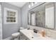 Renovated bathroom with sleek vanity, framed mirror and a combination of gray tile at 2536 Cambridge Dr, Lancaster, SC 29720