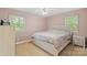 Charming bedroom with a decorative bed, neutral carpeting, and ample natural light from dual windows at 2536 Cambridge Dr, Lancaster, SC 29720