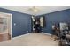 Navy bedroom with a ceiling fan and desk illuminated by natural light from the window at 2536 Cambridge Dr, Lancaster, SC 29720
