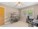 Neutral bedroom featuring a ceiling fan, shelving unit, and natural light streaming through the window at 2536 Cambridge Dr, Lancaster, SC 29720