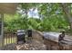 Outdoor deck featuring multiple grilling options, surrounded by lush greenery at 2536 Cambridge Dr, Lancaster, SC 29720