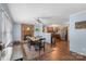 Open dining area with fireplace, wood floors, and seamless flow into the modern kitchen at 2536 Cambridge Dr, Lancaster, SC 29720