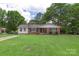Well-maintained ranch-style home featuring a spacious front yard and mature trees at 2536 Cambridge Dr, Lancaster, SC 29720