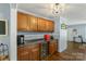 Kitchen space with dark countertops, wood cabinets and view to additional sitting and dining areas at 2536 Cambridge Dr, Lancaster, SC 29720