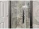 Gray tile combination shower featuring glass doors and black fixtures at 2536 Cambridge Dr, Lancaster, SC 29720