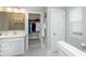 Bright bathroom with white cabinets, tile floor, and walk-in closet for storage at 25952 Appleyard Ct, Lancaster, SC 29720