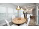 Bright dining area features a round wood table, white chairs, and ample natural light from the windows at 25952 Appleyard Ct, Lancaster, SC 29720