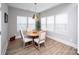 Cozy dining room featuring a round wooden table, four chairs, and ample natural light at 25952 Appleyard Ct, Lancaster, SC 29720