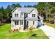 Beautiful two-story home with gray siding, white trim, a brick foundation, and a two-car garage at 277 Triple Ponds Ct # 12, Clover, SC 29710
