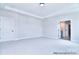 Expansive bedroom with neutral carpet, tray ceiling, and ensuite bathroom entrance at 277 Triple Ponds Ct, Clover, SC 29710
