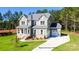 Charming two-story home with manicured lawn and a welcoming covered porch at 277 Triple Ponds Ct, Clover, SC 29710