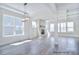 Bright and airy living room with a stone fireplace and ample natural light from large windows at 277 Triple Ponds Ct, Clover, SC 29710