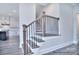 Elegant staircase features wood treads and black iron balusters leading to the upper level at 277 Triple Ponds Ct, Clover, SC 29710
