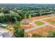 Aerial view showcasing a property with trees, surrounding community, and nearby amenities at 3006 Constitution Ln, Gastonia, NC 28056