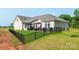 Beautiful backyard features a well-manicured lawn, black metal fence, and outdoor patio with seating and grill at 3006 Constitution Ln, Gastonia, NC 28056