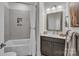 Bathroom with a tub, shower, and a vanity with a framed mirror and modern lighting fixtures at 3006 Constitution Ln, Gastonia, NC 28056