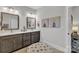 Bathroom featuring double sinks with dark wood cabinets, a tiled floor and vanity stool at 3006 Constitution Ln, Gastonia, NC 28056