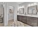 Bathroom featuring double sinks with dark wood cabinets and a tiled floor at 3006 Constitution Ln, Gastonia, NC 28056