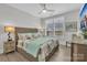 Bright bedroom featuring a bed with nautical themed bedding and a window with plantation shutters at 3006 Constitution Ln, Gastonia, NC 28056