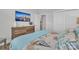 Bedroom featuring dresser with TV, white door and closet with full mirrored sliding doors at 3006 Constitution Ln, Gastonia, NC 28056