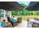 Outdoor patio area with comfortable seating, dining space, two umbrellas and a grill at 3006 Constitution Ln, Gastonia, NC 28056