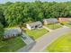 An aerial view showcases homes with green lawns on a tree lined street at 3608 Crestridge Dr, Charlotte, NC 28217