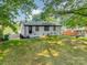 A large backyard features a manicured lawn and mature trees at 3608 Crestridge Dr, Charlotte, NC 28217