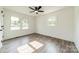 The bedroom has wood-look floors and dual windows, bringing in natural light at 3608 Crestridge Dr, Charlotte, NC 28217