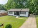 Updated brick home with white paint, black accents, and fresh landscaping at 3608 Crestridge Dr, Charlotte, NC 28217