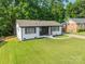 Charming home with freshly cut lawn and white painted brick exterior, accentuated with black trim and shutters at 3608 Crestridge Dr, Charlotte, NC 28217