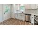 The kitchen features stainless steel appliances, stone counters, and white cabinets at 3608 Crestridge Dr, Charlotte, NC 28217