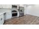 Bright kitchen features stainless appliances, white cabinets and plenty of counter space on wood-look floors at 3608 Crestridge Dr, Charlotte, NC 28217