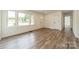 An open living space features bright white paint, wood-look floors, and large windows at 3608 Crestridge Dr, Charlotte, NC 28217