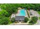 Aerial view of a community pool and clubhouse with well-maintained landscaping, seating, and a parking area at 4006 Centerview Dr, Indian Trail, NC 28079