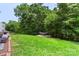 Backyard featuring a well-maintained lawn, trees, patio furniture, and a hammock, creating a relaxing outdoor space at 4006 Centerview Dr, Indian Trail, NC 28079